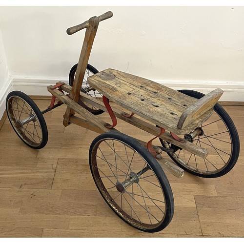 32 - A mid twentieth century child's hand powered rolling cart utilising a push-pull mechanism featuring ... 