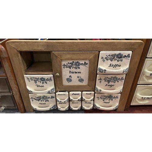 37 - Three vintage wall-mounted spice racks, including ceramic and glass drawer examples. Some damage and... 