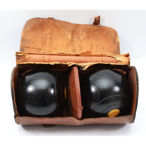 60 - A cased pair of Crown Green bowls, each stamped 'R38'.