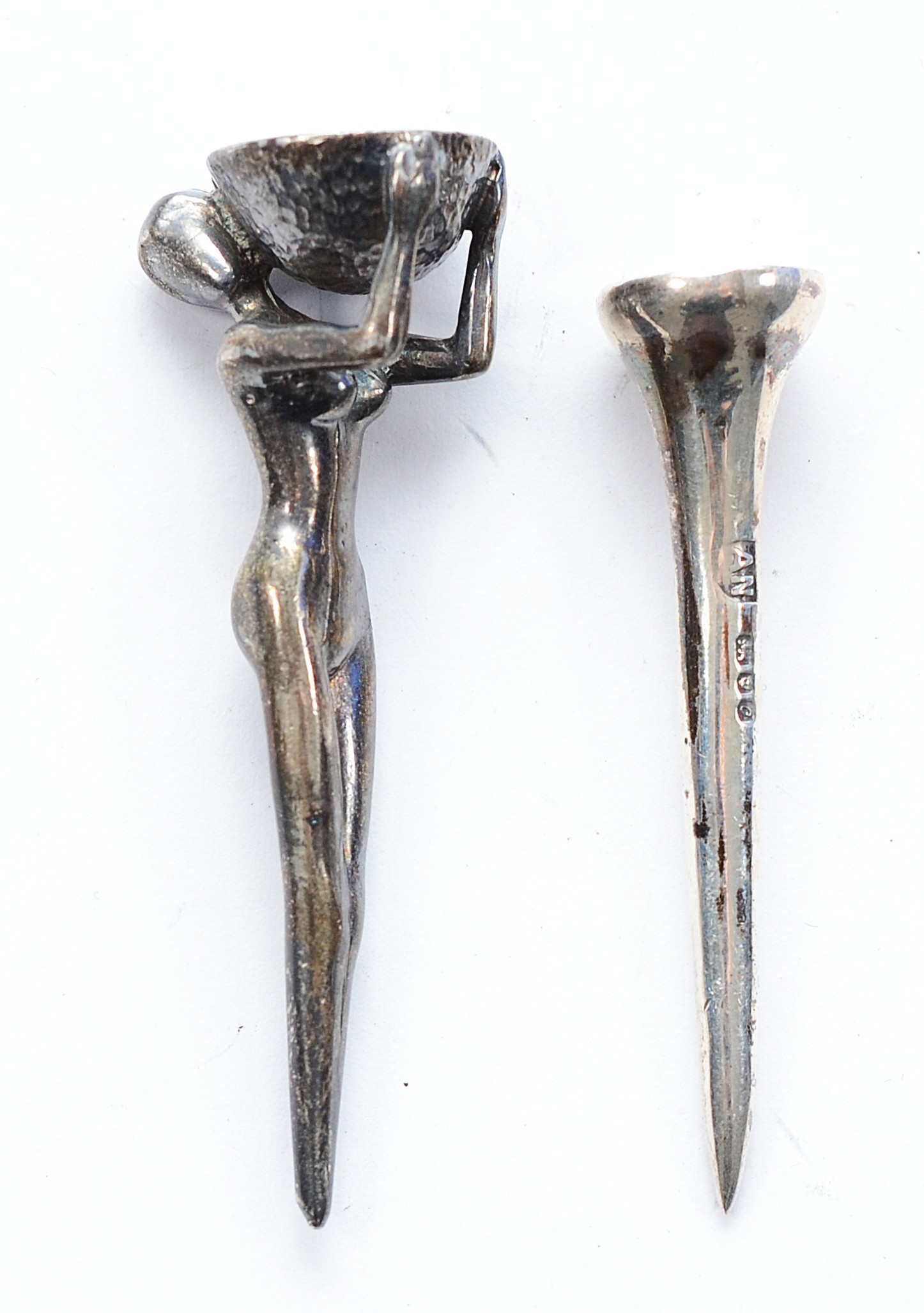 A silver golf tee, in the form of a nude Woman, London 1986, together ...