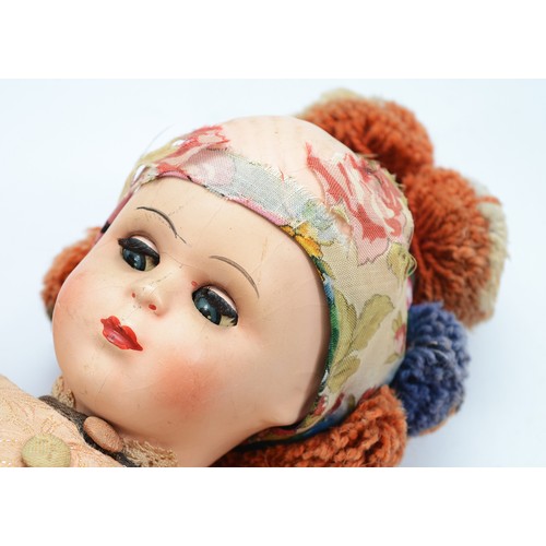 A Hungarian matyo folk costume doll with articulated head, arms and ...