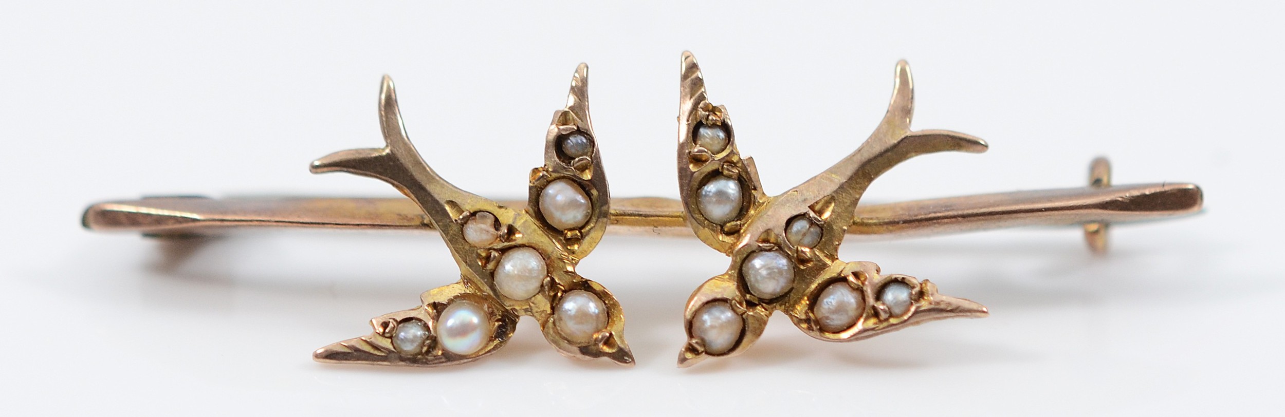A 9ct gold and seed pearl swallow brooch, base metal pin, Chester ...
