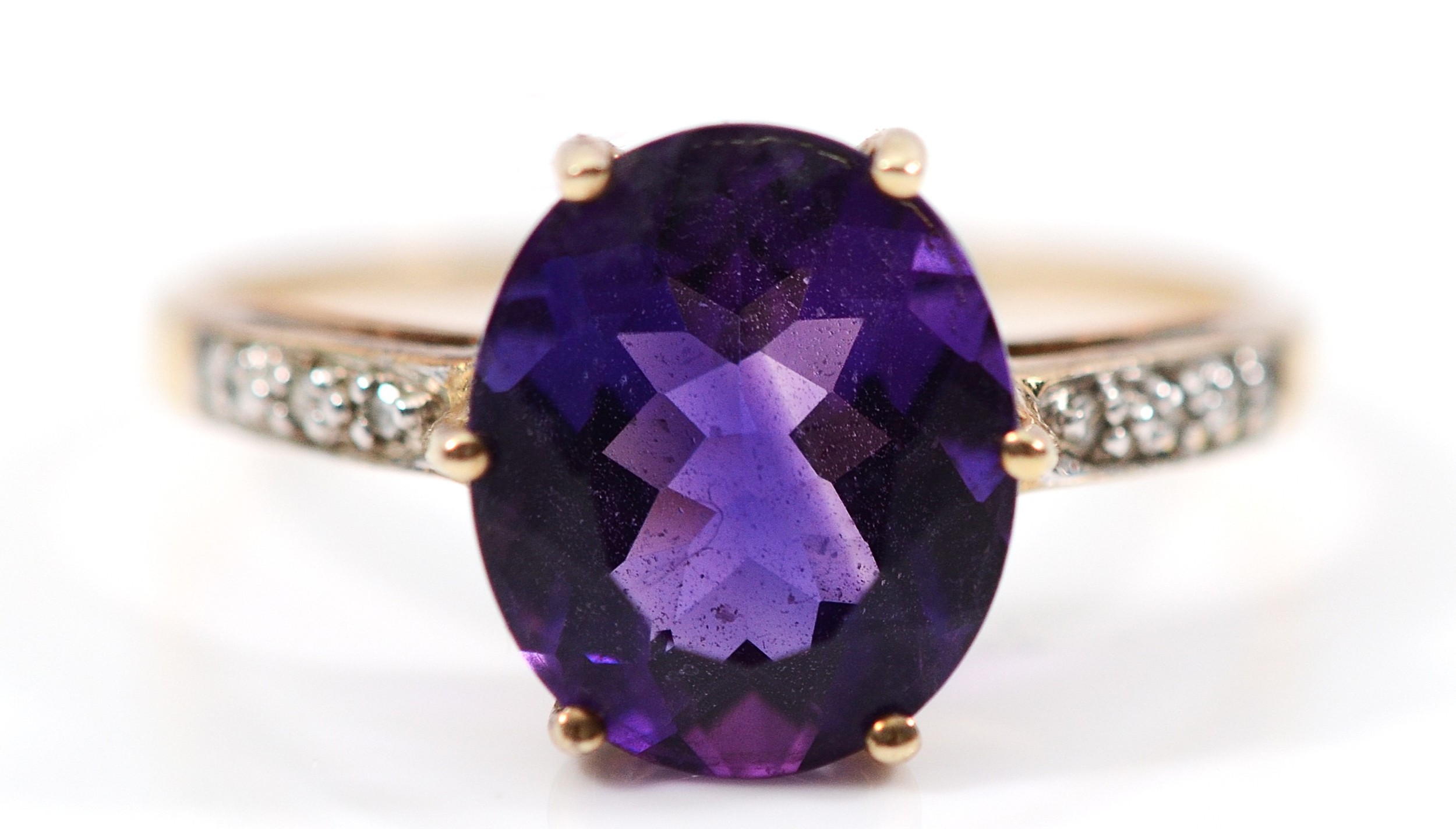 A 9ct gold amethyst dress ring, with single cut diamond set shoulders ...