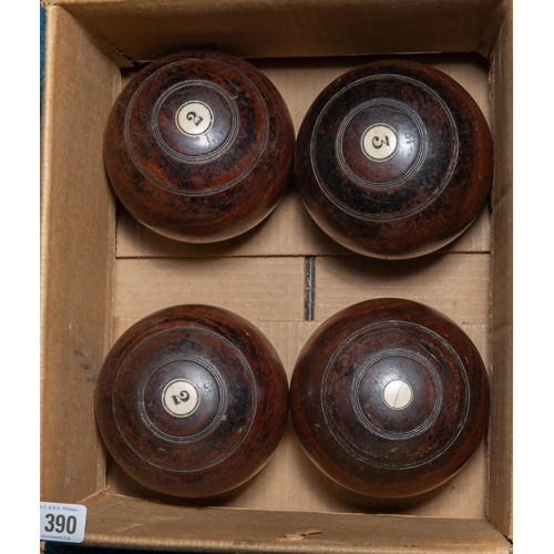 390 - FOUR WOODEN LAWN BOWLS