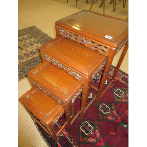 590 - Oriental Style Nest of Oak Glass Topped Tables with Pierced Carving