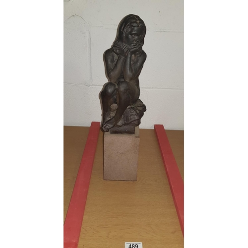 489 - 20th century matte bronze glazed and slip cast ceramic sculpture of a seated nude girl