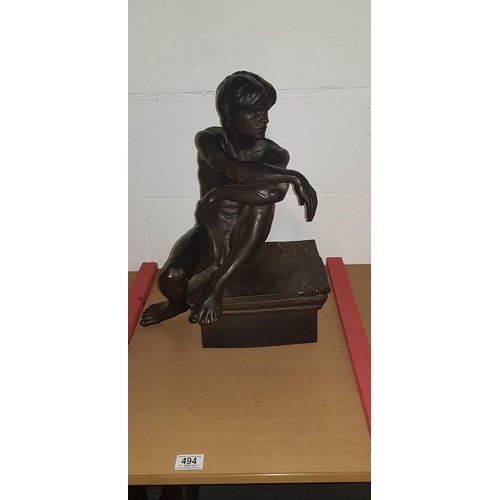 494 - A Large 20th century matte bronze glazed and slip cast ceramic sculpture of a seated nude male