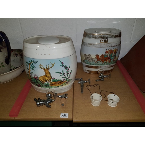 437 - 2 large ceramic spirit barrels with taps and drip containers