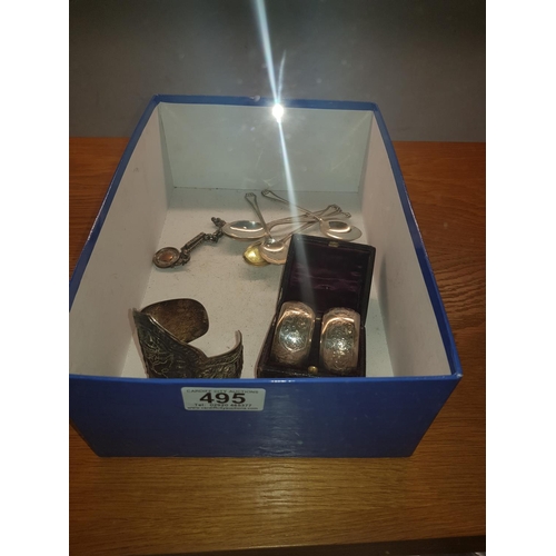 495 - A silver fob, a boxed pair of silver serviette rings , 5 silver teaspoons and a chinese silver brace... 