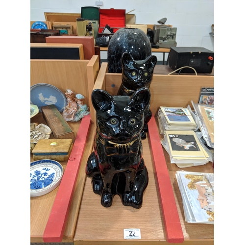 22 - A pair of early black ceramic cats with glass eyes