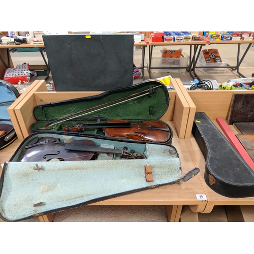 48 - Two violins in cases and an empty violin case