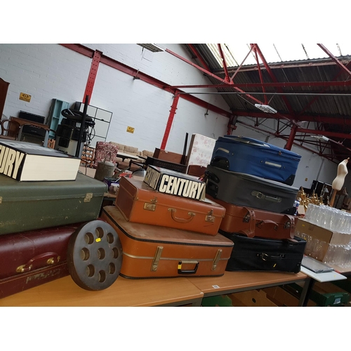 828 - A quantity of vintage suitcases, picture frames etc