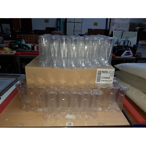 829 - A quantity of plastic champagne flutes