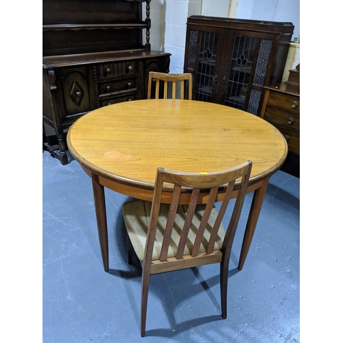 269 - G Plan teak circular extendable dining table with two chairs