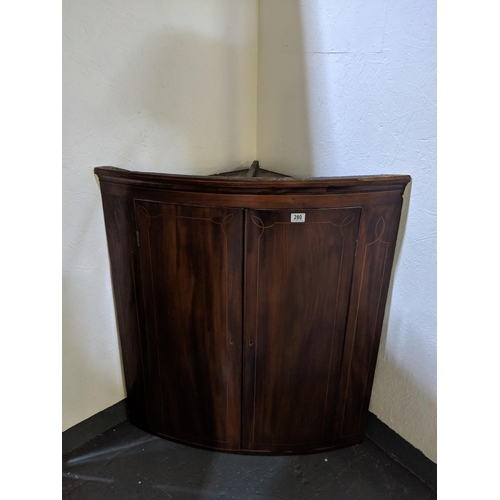 280 - Bow fronted mahogany wall hanging corner cabinet