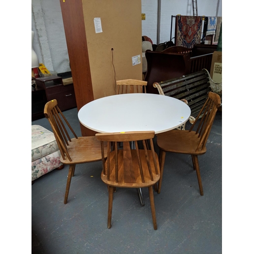 722 - Metal framed, wooden top circular table and four chairs