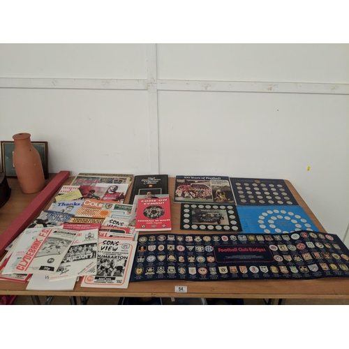 54 - A selection of sporting programmes, presentation collectors coins and sticker badges