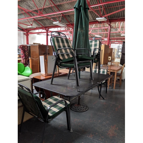 774 - A metal patio table, 6 chairs and umbrella