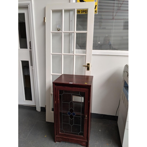 793 - A wooden cabinet and a 15 panel glazed door