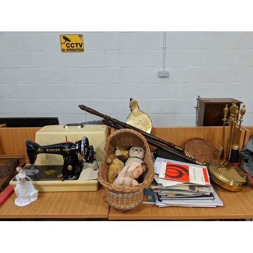 12 - Brass and copper warming pans, a Singer sewing machine, brass fire irons etc.