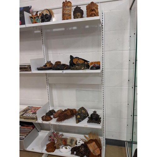 55 - Collection of wooden and ceramic masks- 4 shelves