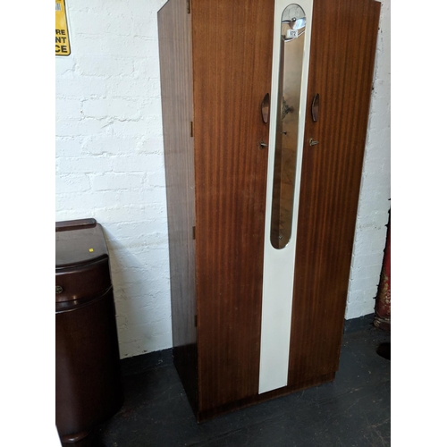 672 - A vintage two door wardrobe