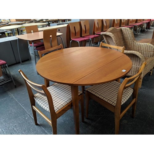 676 - A circular dining table and four chairs