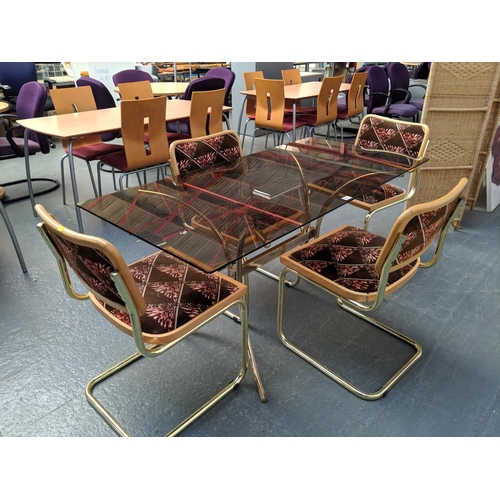 681 - A glass topped dining table and four chairs