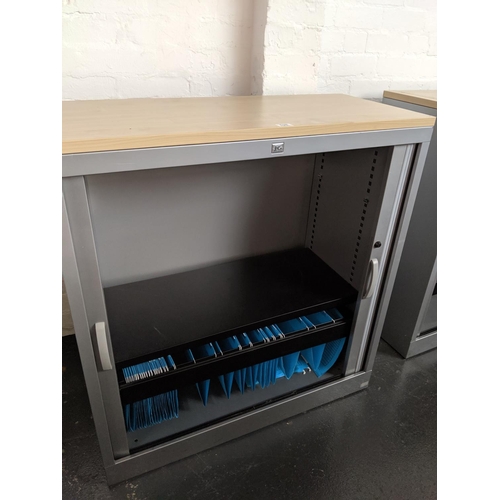 528 - A metal office cabinet with roller doors