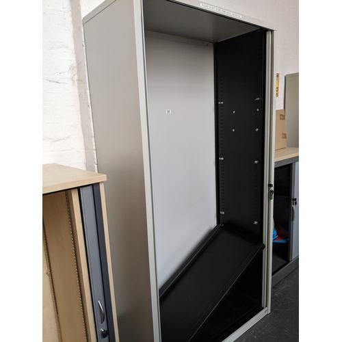 534 - Large metal office stationary cupboard with roller doors