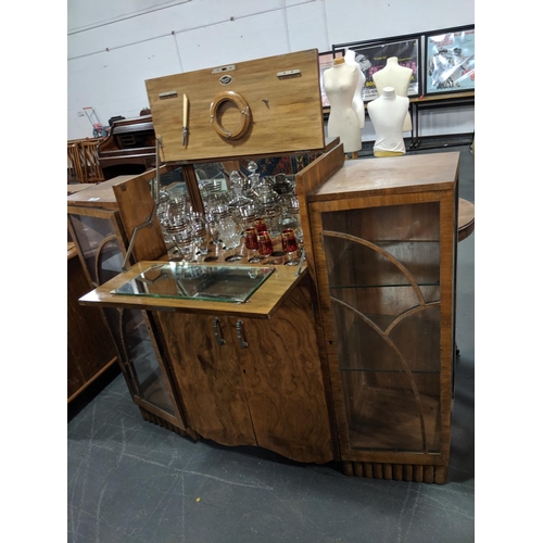 229 - A 1930's walnut cocktail cabinet plus contents