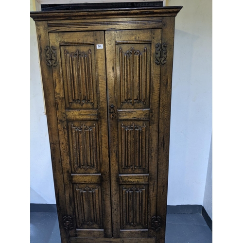 248 - An early solid oak two door wardrobe with linen fold carving