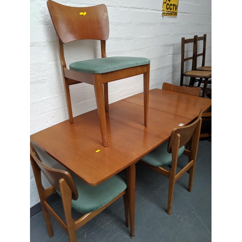 512 - A teak extending dining table and four chairs