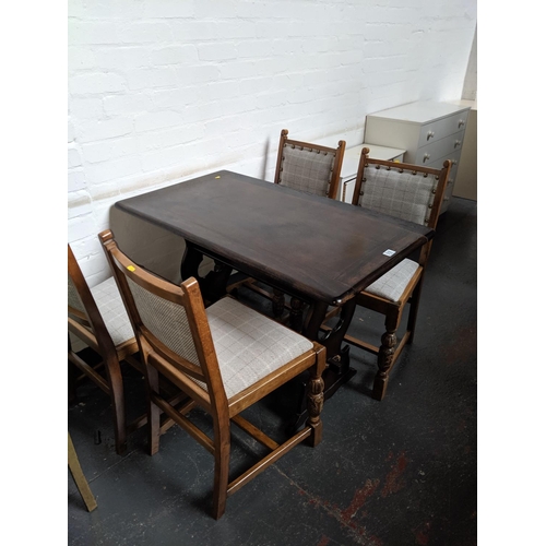 518 - An oak dining table and four chairs