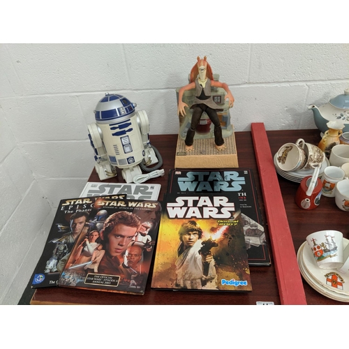 44 - An RTD2 telephone and a Star Wars figure together with annuals and books