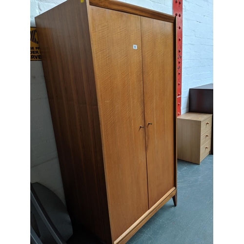 660 - A Younger 2 door teak fitted wardrobe