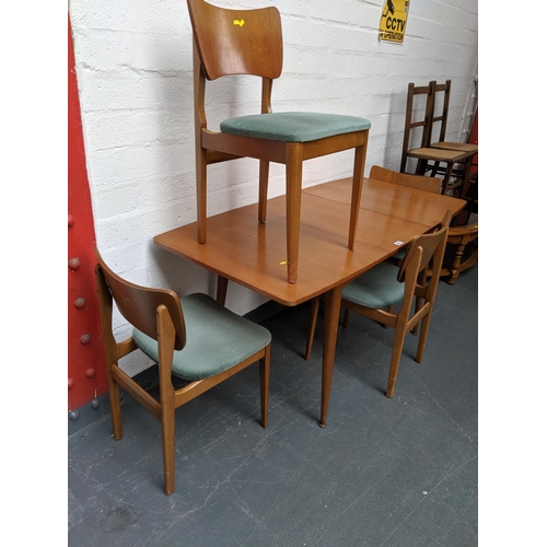 663 - A teak dining table and four chairs