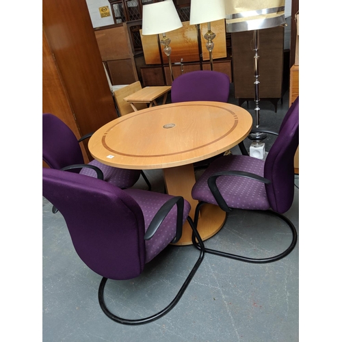 710 - A circular office table and four orangebox chairs
