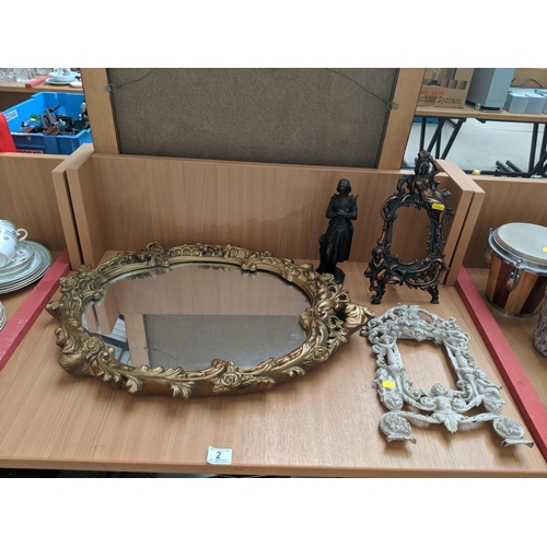 2 - An oval gilt framed mirror, two Victorian table top ornate picture frames and a bronze statue