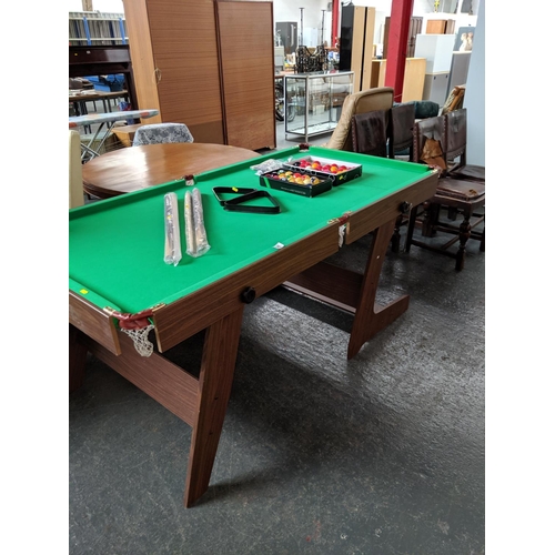 706 - Snooker table with snooker balls and cues, scoreboard and brush