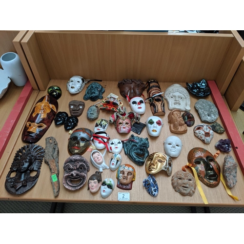2 - A collection of porcelain and wooden masks etc.