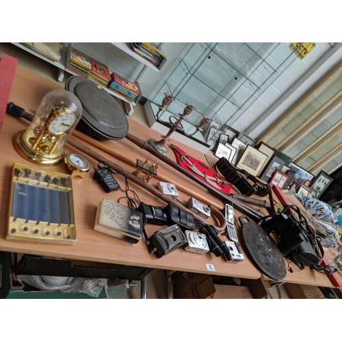35 - A quantity of mixed miscellaneous items including bakestone, binoculars etc.