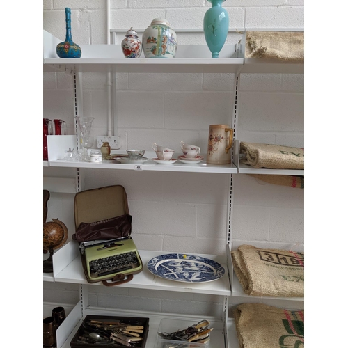49 - Four shelves of mixed items including oriental china, flatware etc.