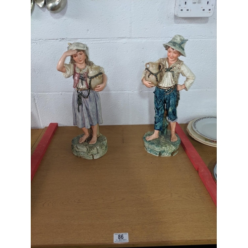 86 - A pair of large Austrian- glazed children water carrier figures - 430mm high