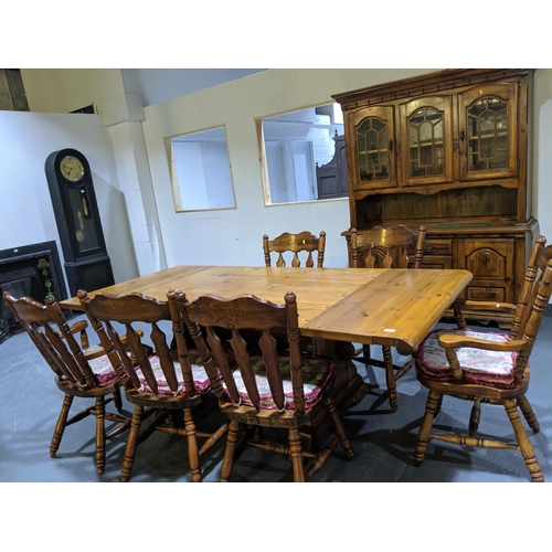 233 - A large dining table, six chairs and a dresser