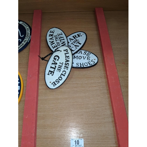 10 - Four oval cast iron signs