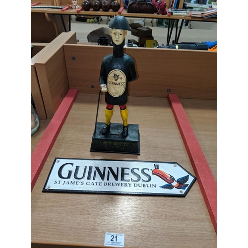 21 - A cast iron Guinness figure and sign