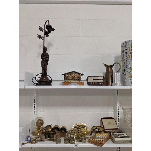 66 - A figural lamp, brassware etc - two shelves