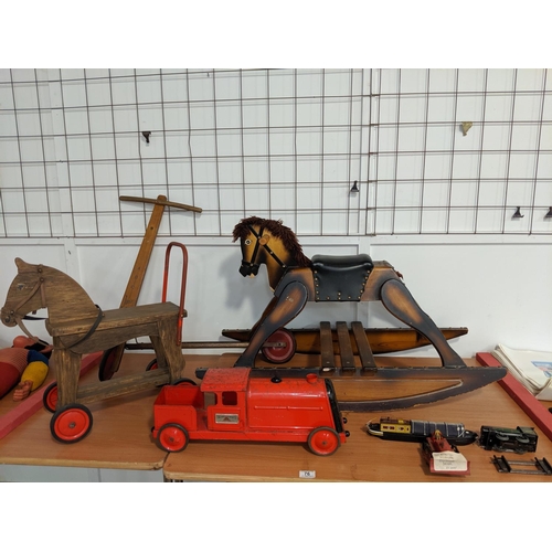 76 - A rocking horse, scooter, Triang tin train, Dinky bulldozer etc.