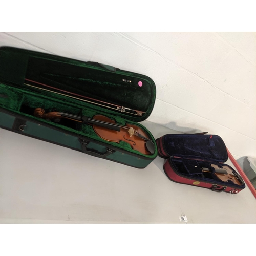 90 - Two violins in cases- one 1/4 size